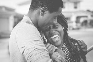 A black and white image of a couple laughing